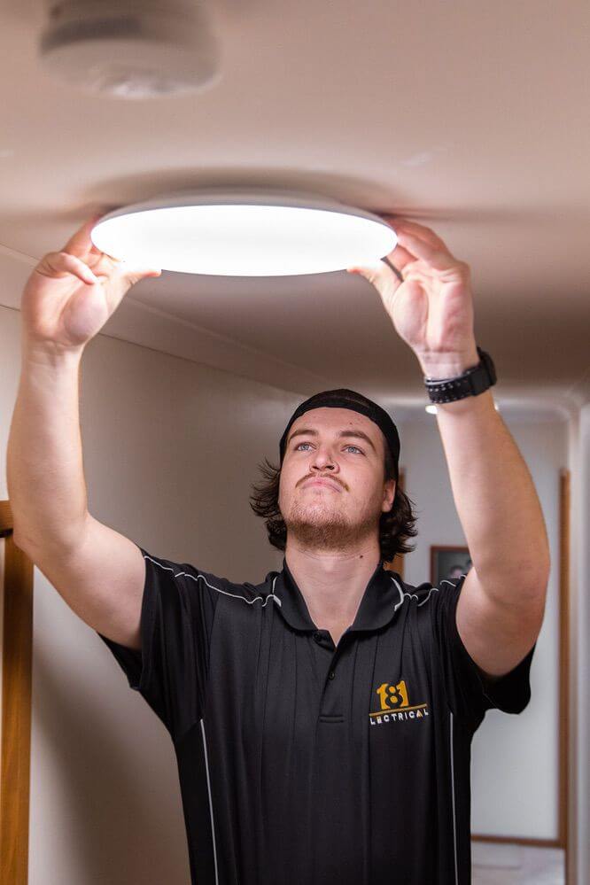 181 Electrical team installing a light